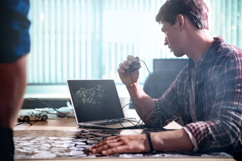 Picture of people working on a computer